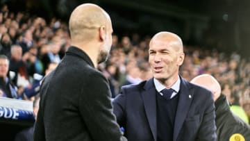 Josep Guardiola, manager of Manchester City greets Zinedine Zidane, manager of Real Madrid (Photo by Sonia Canada/Getty Images)
