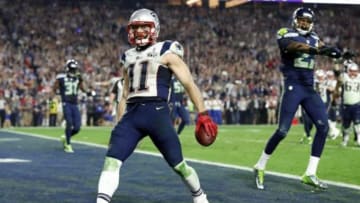 Feb 1, 2015; Glendale, AZ, USA; New England Patriots wide receiver Julian Edelman (11) celebrates scoring a touchdown against Seattle Seahawks cornerback Tharold Simon (27) during the fourth quarter in Super Bowl XLIX at University of Phoenix Stadium. Mandatory Credit: Matthew Emmons-USA TODAY Sports