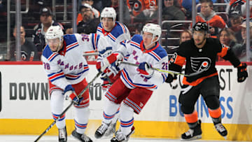 PHILADELPHIA, PA - NOVEMBER 23: Steven Fogarty #38 of the New York Rangers looks to pass the puck with teammates Jimmy Vesey #26 and Brady Skjei #76 against Tryell Goulbourne #39 of the Philadelphia Flyers on November 23, 2018 at the Wells Fargo Center in Philadelphia, Pennsylvania. (Photo by Len Redkoles/NHLI via Getty Images)