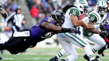 Nov 24, 2013; Baltimore, MD, USA; New York Jets wide receiver Josh Cribbs (16) gets tackled by Baltimore Ravens linebacker Courtney Upshaw (91) at M