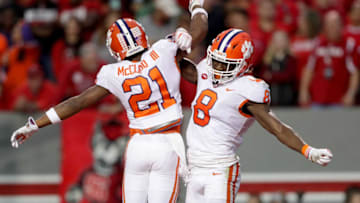 RALEIGH, NC - NOVEMBER 04: Deon Cain #8 celebrates after scoring a touchdown with teammate Ray-Ray McCloud #21 of the Clemson Tigers during their game against the North Carolina State Wolfpack at Carter Finley Stadium on November 4, 2017 in Raleigh, North Carolina. (Photo by Streeter Lecka/Getty Images)