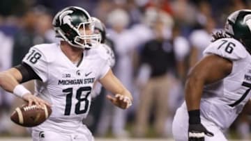 Dec 5, 2015; Indianapolis, IN, USA; Michigan State Spartans quarterback Connor Cook (18) looks to pass during the third quarter against the Iowa Hawkeyes in the Big Ten Conference football championship game at Lucas Oil Stadium. Mandatory Credit: Brian Spurlock-USA TODAY Sports