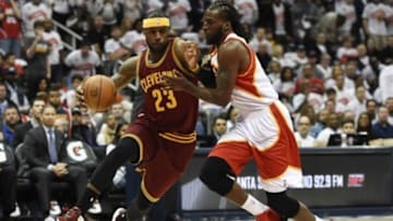 Mar 6, 2015; Atlanta, GA, USA; Cleveland Cavaliers forward LeBron James (23) dribbles the ball as Atlanta Hawks forward DeMarre Carroll (5) defends during the first half at Philips Arena. Mandatory Credit: Dale Zanine-USA TODAY Sports