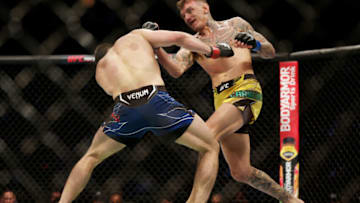 HOUSTON, TEXAS - FEBRUARY 12: Renato Moicano of Brazil punches Alexander Hernandez in their lightweight fight during UFC 271 at Toyota Center on February 12, 2022 in Houston, Texas. (Photo by Carmen Mandato/Getty Images)