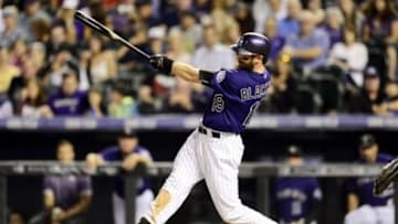 Sep 25, 2015; Denver, CO, USA; Colorado Rockies center fielder Charlie Blackmon (19) hits a solo home run in the fourth inning against the Los Angeles Dodgers at Coors Field. Mandatory Credit: Ron Chenoy-USA TODAY Sports