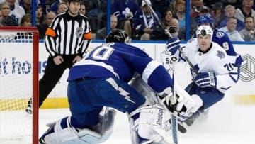 Feb 6, 2014; Tampa, FL, USA; Toronto Maple Leafs right wing David Clarkson (71) looks at the puck as Tampa Bay Lightning goalie Ben Bishop (30) defends during the first period at Tampa Bay Times Forum. Mandatory Credit: Kim Klement-USA TODAY Sports
