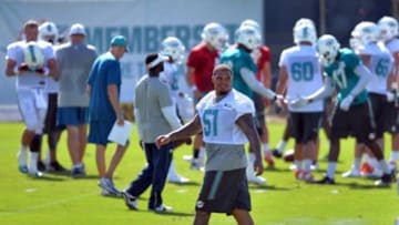 Jul 25, 2014; Davie, FL, USA; Miami Dolphins center Mike Pouncey (51) walks around the practice field during practice at Miami Dolphins Training Facility. Mandatory Credit: Steve Mitchell-USA TODAY Sports