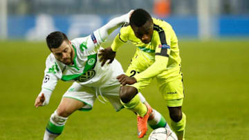 GENT, BELGIUM - FEBRUARY 17: Moses Simon of KAA Gent shrugs off the challenge from Vierinha of Wolfsburg during the UEFA Champions League round of 16, first leg match between KAA Gent and VfL Wolfsburg at Ghelamco Arena on February 17, 2016 in Gent, Belgium. (Photo by Dean Mouhtaropoulos/Getty Images)