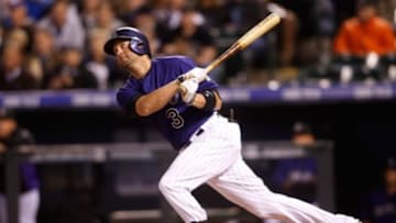 Apr 8, 2014; Denver, CO, USA; Colorado Rockies right fielder Michael Cuddyer (3) hits a home run during the fourth inning against the Chicago White Sox at Coors Field. Mandatory Credit: Chris Humphreys-USA TODAY Sports