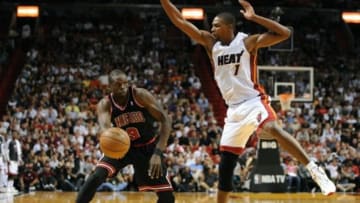 Jan 4, 2013; Miami, FL, USA; Chicago Bulls small forward Luol Deng (9) is pressured by Miami Heat center Chris Bosh (1) during the first half at American Airlines Arena. Mandatory Credit: Steve Mitchell-USA TODAY Sports