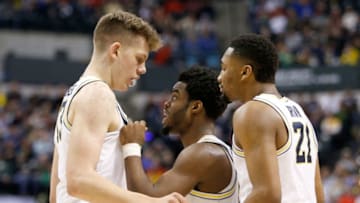 INDIANAPOLIS, IN - MARCH 17: Derrick Walton Jr. #10 of the Michigan Wolverines talks with Moritz Wagner #13 and Zak Irvin #21 against the Oklahoma State Cowboys during the first round of the 2017 NCAA Men's Basketball Tournament at Bankers Life Fieldhouse on March 17, 2017 in Indianapolis, Indiana. (Photo by Joe Robbins/Getty Images)