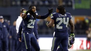January 10, 2015; Seattle, WA, USA; Seattle Seahawks running back Marshawn Lynch (24) is greeted by cornerback Richard Sherman (25) after running the ball against the Carolina Panthers during the second half in the 2014 NFC Divisional playoff football game at CenturyLink Field. Mandatory Credit: Joe Nicholson-USA TODAY Sports