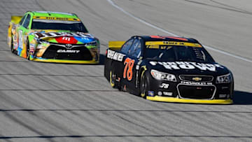 Sep 20, 2015; Joliet, IL, USA; NASCAR Sprint Cup Series driver Martin Truex Jr. (78) leads NASCAR Sprint Cup Series driver Kyle Busch (18) during the MyAfibRisk.com 400 at Chicagoland Speedway. Mandatory Credit: Jasen Vinlove-USA TODAY Sports