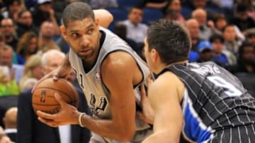 Nov 29, 2013; Orlando, FL, USA; San Antonio Spurs power forward Tim Duncan (21) is pressured by Orlando Magic center Nikola Vucevic (9) during the second half at Amway Center. Mandatory Credit: Steve Mitchell-USA TODAY Sports
