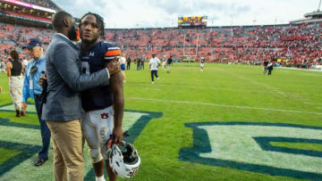 Auburn football linebacker Zakoby McClain (9) gets a hug from Auburn athletics director Allen Greeene after the game at Jordan-Hare Stadium in Auburn, Ala., on Saturday, Oct. 9, 2021. Georgia Bulldogs defeated the Auburn Tigers 34-10.