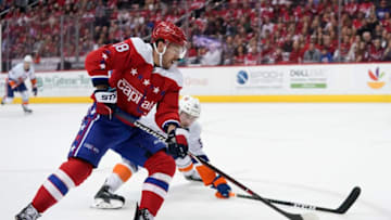 WASHINGTON, DC - APRIL 06: Chandler Stephenson #18 of the Washington Capitals skates with the puck against Johnny Boychuk #55 of the New York Islanders in the first period at Capital One Arena on April 6, 2019 in Washington, DC. (Photo by Patrick McDermott/NHLI via Getty Images)