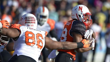 Jan 24, 2015; Mobile, AL, USA; North squad running back Ameer Abdullah of Nebraska (28) runs past the tackle attempt of South squad defensive end Trey Flowers of Arkansas (86) in the first quarter of the Senior Bowl at Ladd-Peebles Stadium. Mandatory Credit: Glenn Andrews-USA TODAY Sports