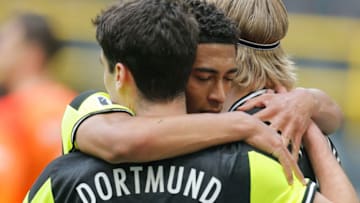 Dortmund's Norwegian forward Erling Braut Haaland (R) celebrates scoring the 2-1 goal from the penalty spot with his team-mates Dortmund's English midfielder Jude Bellingham (C) and Dortmund's US midfielder Giovanni Reyna during the German first division Bundesliga football match between Borussia Dortmund and SV Werder Bremen in Dortmund, western Germany, on April 18, 2021. - DFL REGULATIONS PROHIBIT ANY USE OF PHOTOGRAPHS AS IMAGE SEQUENCES AND/OR QUASI-VIDEO (Photo by LEON KUEGELER / POOL / AFP) / DFL REGULATIONS PROHIBIT ANY USE OF PHOTOGRAPHS AS IMAGE SEQUENCES AND/OR QUASI-VIDEO (Photo by LEON KUEGELER/POOL/AFP via Getty Images)