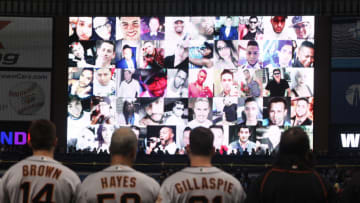 ST. PETERSBURG, FL - JUNE 17: Members of the San Francisco Giants look on during a moment of silence in honor of the victims of the Orlando nightclub shooting during the Tampa Bay Rays' Pride Night before the start of a game between the Giants and the Rays on June 17, 2016 at Tropicana Field in St. Petersburg, Florida. (Photo by Brian Blanco/Getty Images)