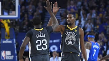 OAKLAND, CA - FEBRUARY 06: Kevin Durant #35 of the Golden State Warriors is congratulated by Draymond Green #23 after Durant scored and was fouled on the shot against the Oklahoma City Thunder during the first half of their NBA basketball game at ORACLE Arena on February 6, 2018 in Oakland, California. NOTE TO USER: User expressly acknowledges and agrees that, by downloading and or using this photograph, User is consenting to the terms and conditions of the Getty Images License Agreement. (Photo by Thearon W. Henderson/Getty Images)