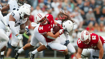 Sep 4, 2021; Madison, Wisconsin, USA; Wisconsin Badgers tight end Jake Ferguson (84) is tackled after catching a pass during the first quarter against the Penn State Nittany Lions at Camp Randall Stadium. Mandatory Credit: Jeff Hanisch-USA TODAY Sports
