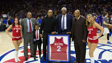 Dec 1, 2015; Philadelphia, PA, USA; Julius Erving shares Philadelphia 76ers legend Moses Malones jersey with family members and fans during a halftime ceremony during a game with the Los Angeles Lakers at Wells Fargo Center. The 76ers won 103-91. Mandatory Credit: Bill Streicher-USA TODAY Sports