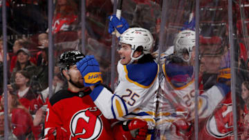 NEWARK, NEW JERSEY - APRIL 21: Owen Power #25 of the Buffalo Sabres celebrates his first NHL goal during the third period as Pavel Zacha #37 of the New Jersey Devils reacts at Prudential Center on April 21, 2022 in Newark, New Jersey. The Buffalo Sabres defeated the New Jersey Devils 5-2. (Photo by Elsa/Getty Images)