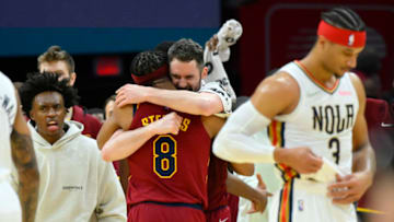 Jan 31, 2022; Cleveland, Ohio, USA; Cleveland Cavaliers guard Collin Sexton (2), left, forward Lamar Stevens (8) and forward Kevin Love (0) celebrate a win as New Orleans Pelicans guard Josh Hart (3) walks off the court at Rocket Mortgage FieldHouse. Mandatory Credit: David Richard-USA TODAY Sports