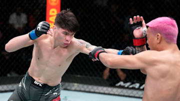 LAS VEGAS, NEVADA - FEBRUARY 26: (L-R) Ignacio Bahamondes of Chile punches Rong Zhu of Tibet in their lightweight fight during the UFC Fight Night event at UFC APEX on February 26, 2022 in Las Vegas, Nevada. (Photo by Chris Unger/Zuffa LLC)