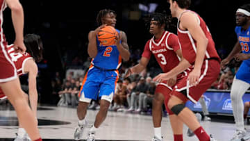 Dec 20, 2022; Charlotte, North Carolina, USA; Florida Gators guard Trey Bonham (2) looks to pass defended by Oklahoma Sooners guard Otega Oweh (3) during the second half at the Jumpman Invitational at the Spectrum Center. Mandatory Credit: Jim Dedmon-USA TODAY Sports
