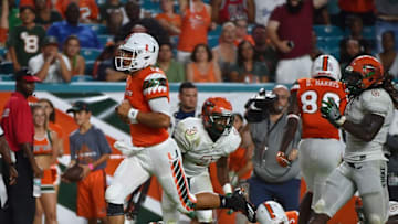Sep 3, 2016; Miami Gardens, FL, USA; Miami Hurricanes quarterback Malik Rosier (12) runs into the end zone to score a touchdown against the Florida A&M Rattlers during the second half at Hard Rock Stadium. The Miami Hurricanes defeat the Florida A&M Rattlers 70-3. Mandatory Credit: Jasen Vinlove-USA TODAY Sports