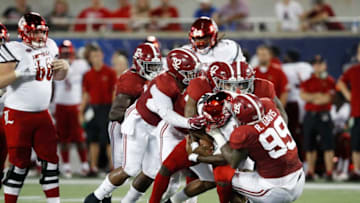 ORLANDO, FL - SEPTEMBER 01: Raekwon Davis #99 of the Alabama Crimson Tide leads a defensive stop against Jawon Pass #4 of the Louisville Cardinals in the second quarter of the game at Camping World Stadium on September 1, 2018 in Orlando, Florida. (Photo by Joe Robbins/Getty Images)
