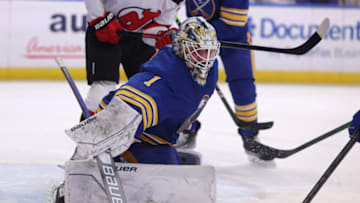 Dec 29, 2021; Buffalo, New York, USA; Buffalo Sabres goaltender Ukko-Pekka Luukkonen (1) clears the puck after save during the third period against the New Jersey Devils at KeyBank Center. Mandatory Credit: Timothy T. Ludwig-USA TODAY Sports