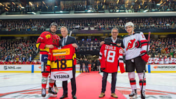 BERN, SWITZERLAND - OCTOBER 01: Jersey exchange from left: Simon Moser #21 of SC Bern, Hugh Weber, President of the New Jersey Devils, Marc Luthi, SC Bern CEO and Swiss player Nico Hischier #13 of New Jersey Devils during the NHL Global Series Challenge Switzerland 2018 match between SC Bern and New Jersey Devils at PostFinance Arena on October 1, 2018 in Bern, Switzerland. (Photo by Robert Hradil/NHLI via Getty Images)