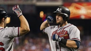 Aug 2, 2013; Philadelphia, PA, USA; Atlanta Braves third baseman Chris Johnson (23) celebrates hitting a home run with second baseman Dan Uggla (26) during the fifth inning against the Philadelphia Phillies at Citizens Bank Park. Mandatory Credit: Howard Smith-USA TODAY Sports