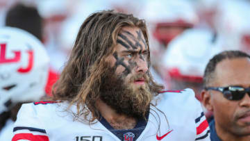 Sophomore defensive lineman Austin Lewis (44) walks on the field as the New Mexico State University Aggies face off against the Liberty University Flames at Aggie Memorial Stadium in Las Cruces on Saturday, Oct. 5, 2019.Nmsu Liberty Football 5