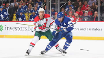 NEWARK, NJ - JANUARY 10: Travis Zajac #19 of the New Jersey Devils battles for the puck against Morgan Rielly #44 of the Toronto Maple Leafs during the game at Prudential Center on January 10, 2019 in Newark, New Jersey. (Photo by Andy Marlin/NHLI via Getty Images)