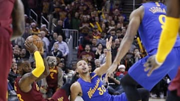 Dec 25, 2016; Cleveland, OH, USA; Cleveland Cavaliers forward LeBron James (32) comes up with a loose ball against Golden State Warriors guard Stephen Curry (30) at Quicken Loans Arena. Cleveland defeats Golden State 109-108. Mandatory Credit: Brian Spurlock-USA TODAY Sports