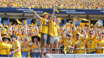 Sep 18, 2021; Morgantown, West Virginia, USA; West Virginia Mountaineers students celebrate after a touchdown from West Virginia Mountaineers running back Leddie Brown (4) during the first quarter against the Virginia Tech Hokies at Mountaineer Field at Milan Puskar Stadium. Mandatory Credit: Ben Queen-USA TODAY Sports