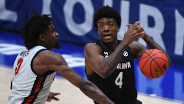 Mar 11, 2021; Nashville, TN, USA; South Carolina Gamecocks forward Jalyn McCreary (4) has the ball knocked away by Mississippi Rebels forward Romello White (0) during the second half at Bridgestone Arena. Mandatory Credit: Christopher Hanewinckel-USA TODAY Sports