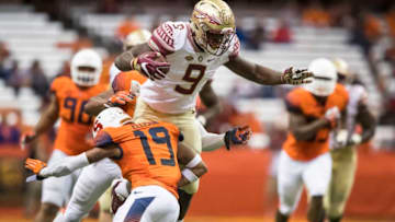 SYRACUSE, NY - NOVEMBER 19: Jacques Patrick #9 of the Florida State Seminoles tries to go over the tackle of Daivon Ellison #19 of the Syracuse Orange during the second half on November 19, 2016 at The Carrier Dome in Syracuse, New York. Florida State defeats Syracuse 45-14. (Photo by Brett Carlsen/Getty Images)