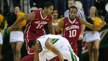 Jan 23, 2016; Waco, TX, USA; Baylor Bears guard Lester Medford (11) loses the ball in front of Oklahoma Sooners guards Isaiah Cousins (11) and Jordan Woodard (10) at the Ferrell Center. Oklahoma won 82-72. Mandatory Credit: Erich Schlegel-USA TODAY Sports