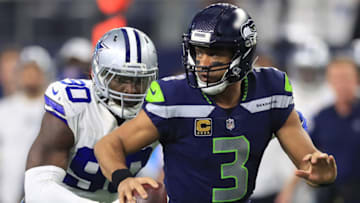 ARLINGTON, TX - DECEMBER 24: Russell Wilson #3 of the Seattle Seahawks runs away from DeMarcus Lawrence #90 of the Dallas Cowboys in the second half at AT&T Stadium on December 24, 2017 in Arlington, Texas. (Photo by Ronald Martinez/Getty Images)