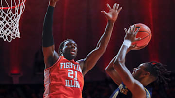 CHAMPAIGN, IL - NOVEMBER 29: Blake Wesley #0 of the Notre Dame Fighting Irish shoots the ball against Kofi Cockburn #21 of the Illinois Fighting Illini at State Farm Center on November 29, 2021 in Champaign, Illinois. (Photo by Michael Hickey/Getty Images)