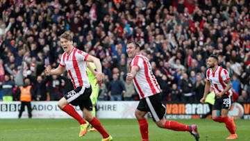 LINCOLN, ENGLAND - MARCH 18: Sean Raggett of Lincoln celebrates scoring their first goal to make it 2-2 on aggregate during the FA Trophy Semi Final, Second Leg match between Lincoln City and York City at Sincil Bank Stadium on March 18, 2017 in Lincoln, England. (Photo by Christopher Lee - The FA/The FA via Getty Images)