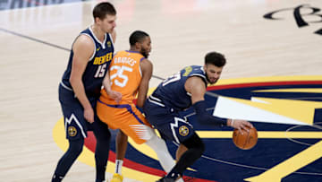 Denver Nuggets: Jamal Murray drives against the Phoenix Suns on a pick set by Nikola Jokic at Ball Arena on January 01, 2021 (Photo by Matthew Stockman/ Getty Images)