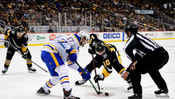 PITTSBURGH, PENNSYLVANIA - DECEMBER 17: Mark Jankowski #17 of the Buffalo Sabres and Drew O'Connor #10 of the Pittsburgh Penguins face off during the third period of a game at PPG PAINTS Arena on December 17, 2021 in Pittsburgh, Pennsylvania. (Photo by Emilee Chinn/Getty Images)