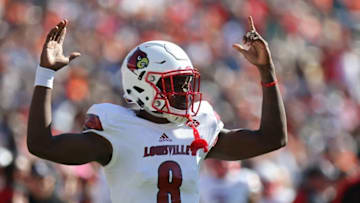 Oct 29, 2016; Charlottesville, VA, USA; Louisville Cardinals quarterback Lamar Jackson (8) celebrates after throwing a touchdown pass against the Virginia Cavaliers in the first quarter at Scott Stadium. Mandatory Credit: Geoff Burke-USA TODAY Sports