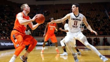 Jan 3, 2015; Blacksburg, VA, USA; Syracuse Orange guard Trevor Cooney (10) looks to shoot while being defended by Virginia Tech Hokies guard Devin Wilson (11) in the first half at Cassell Coliseum. Mandatory Credit: Michael Shroyer-USA TODAY Sports