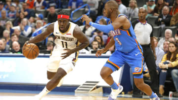 Jrue Holiday #11 of the New Orleans Pelicans drives against Chris Paul #3 of the Oklahoma City Thunder (Photo by Ron Jenkins/Getty Images)